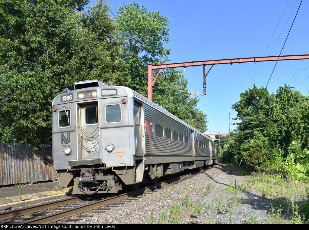 NJT Train # 429 about to cross the Division Avenue Grade Crossing just before making the station stop. Arrow III Cab Car # 1366 is in the lead 